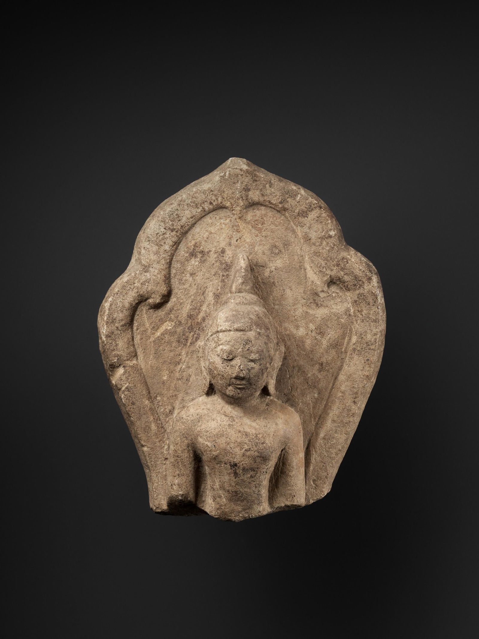 A PYU SANDSTONE FRAGMENT OF BUDDHA, 9TH-10TH CENTURY: A PYU SANDSTONE FRAGMENT OF BUDDHA, 9TH-10TH CENTURY Pyu city-states. The face in a serene expression with arched eyebrows above downcast eyes, a broad nose, and slender lips forming a subtle smile, f