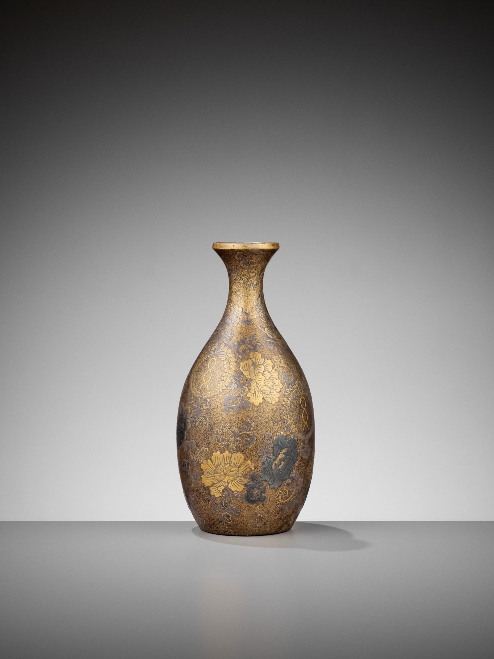 A RARE LACQUERED TOKKURI (SAKE FLASK): A RARE LACQUERED TOKKURI (SAKE FLASK) Japan, late 17th to early 18th century, Edo period (1615-1868)The tokkuri of classic shape, finely decorated in rich gold and silver lacquer, against a densel