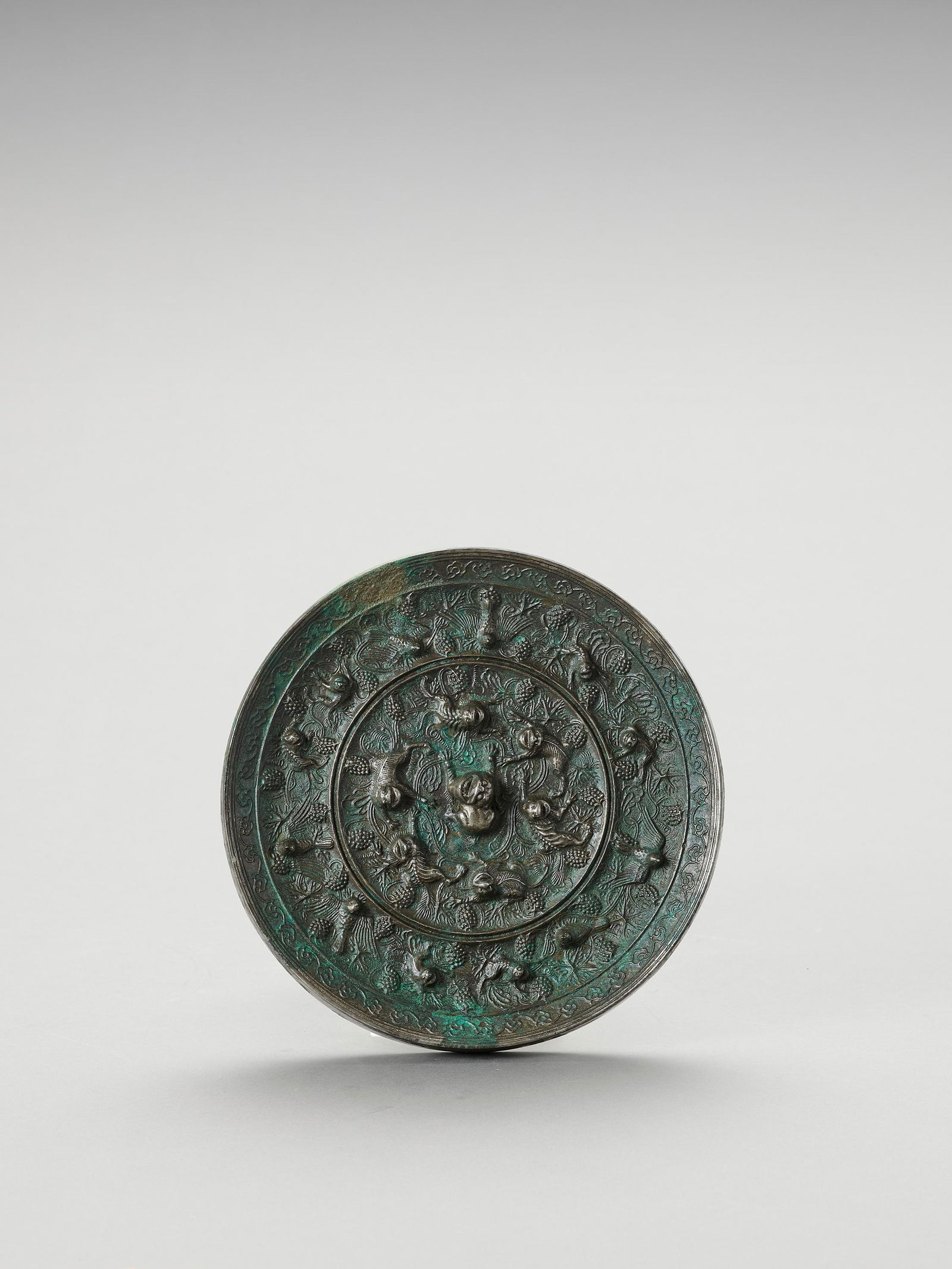 A LARGE BRONZE 'LION AND GRAPEVINE' MIRROR (1 of 4)