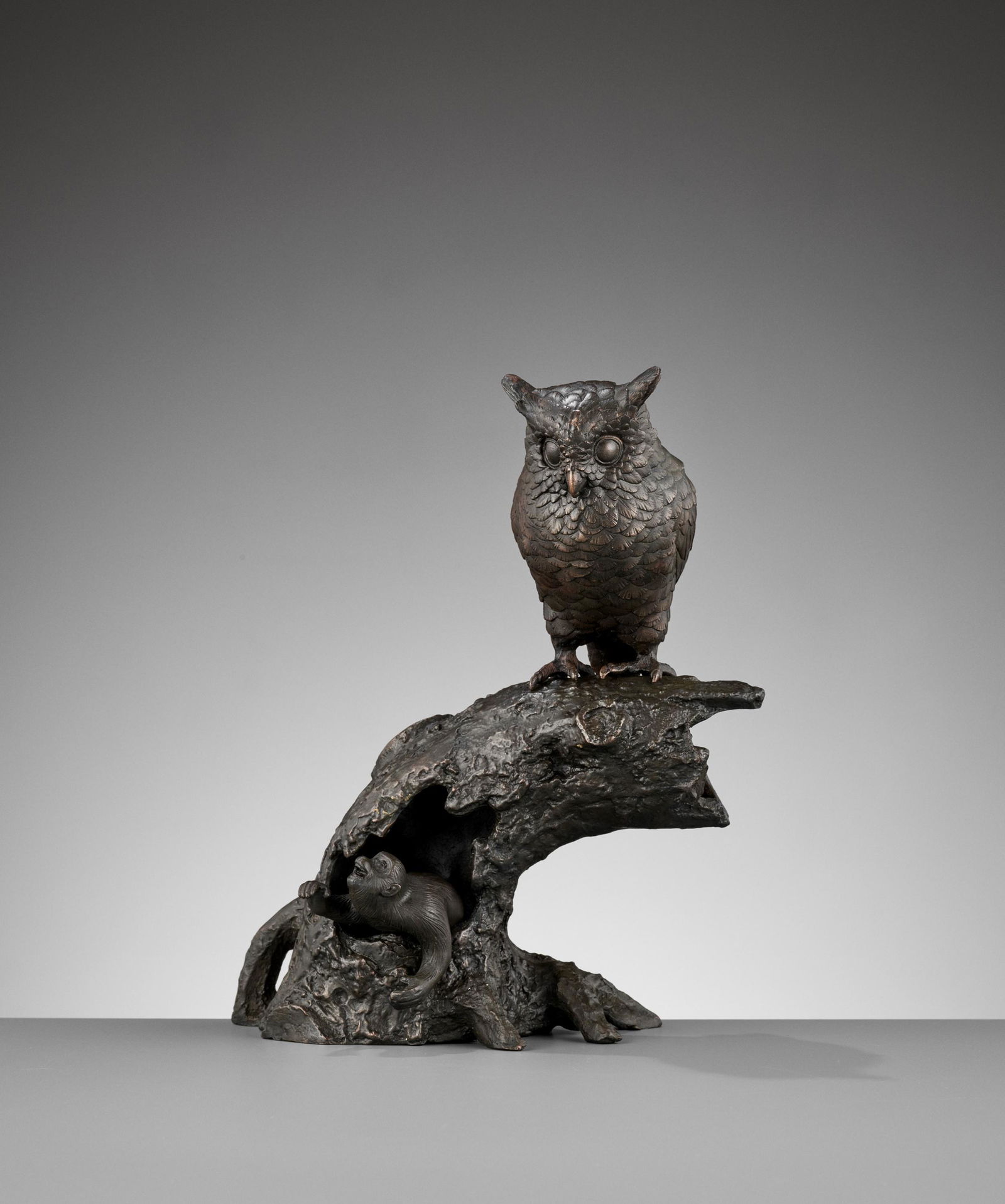 A BRONZE OKIMONO GROUP OF AN OWL AND MONKEY (1 of 11)