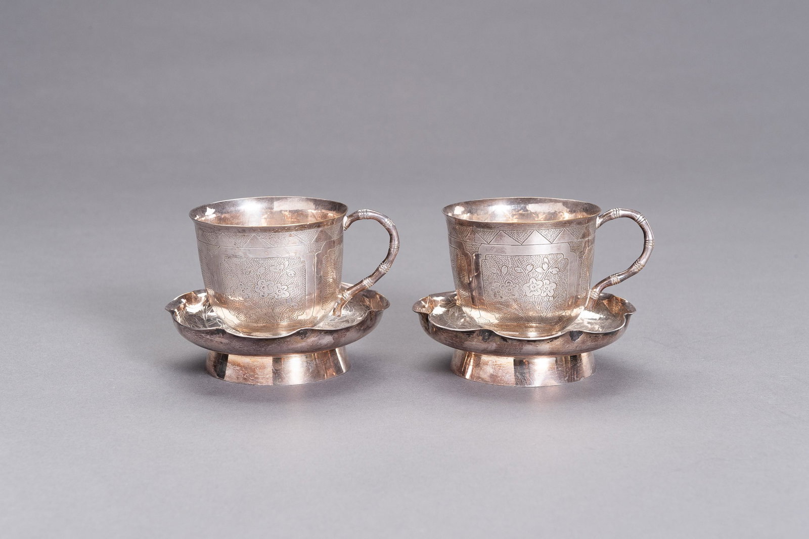 A PAIR OF SILVER CUPS WITH MATCHING SAUCERS (1 of 8)