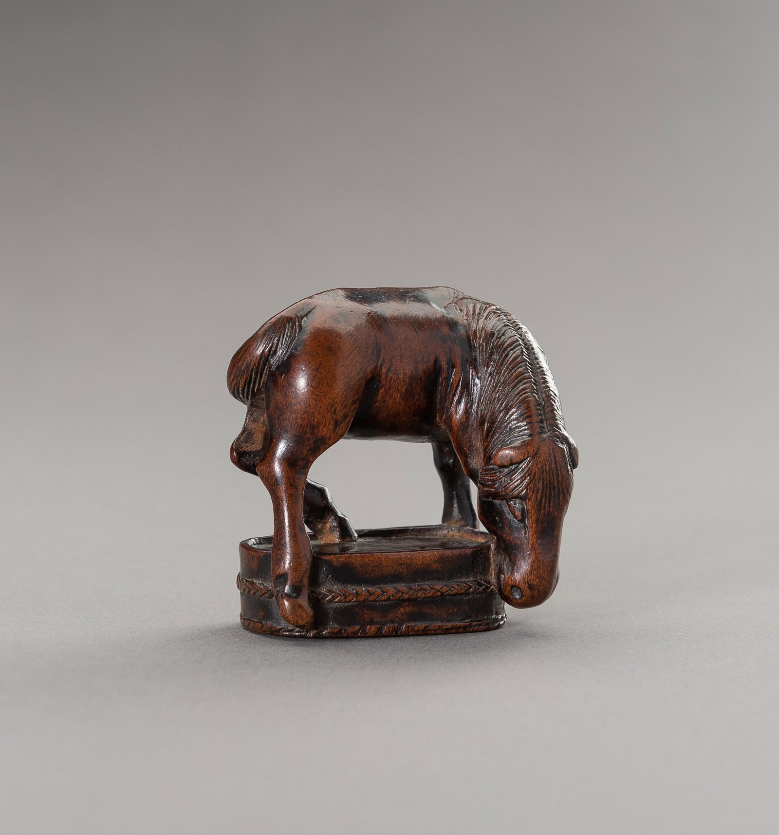 CHOZAN: A BOXWOOD NETSUKE OF A GRAZING HORSE: CHOZAN: A BOXWOOD NETSUKE OF A GRAZING HORSE By Chozan (Tsuyama), signed Chozan 彫山 Japan, 19th century, Edo period (1615-1868) Carved in a bold and dynamic manner, depicting a grazing ho