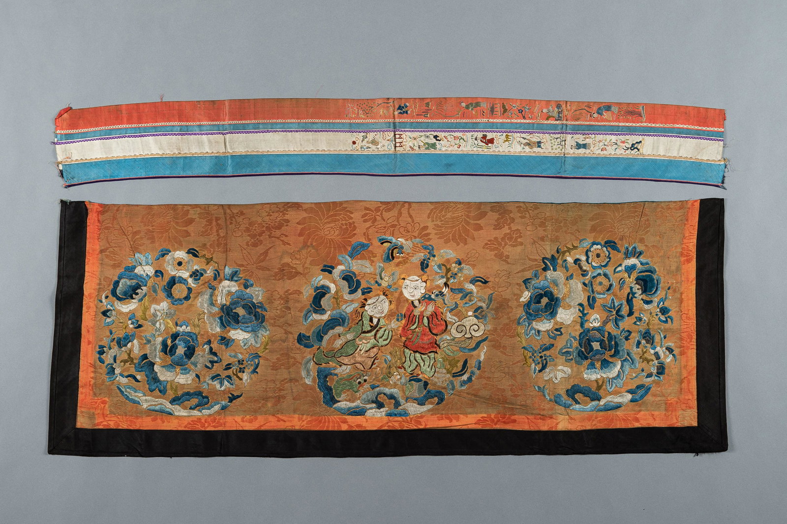 A LOT WITH TWO SILK TEXTILES, QING: A LOT WITH TWO SILK TEXTILES, QING China, late Qing Dynasty (1644-1912). Comprising a silk sleeve band, embroidered in satin stitch and Beijing knot and with gold brocade, depicting figural scenes, fl