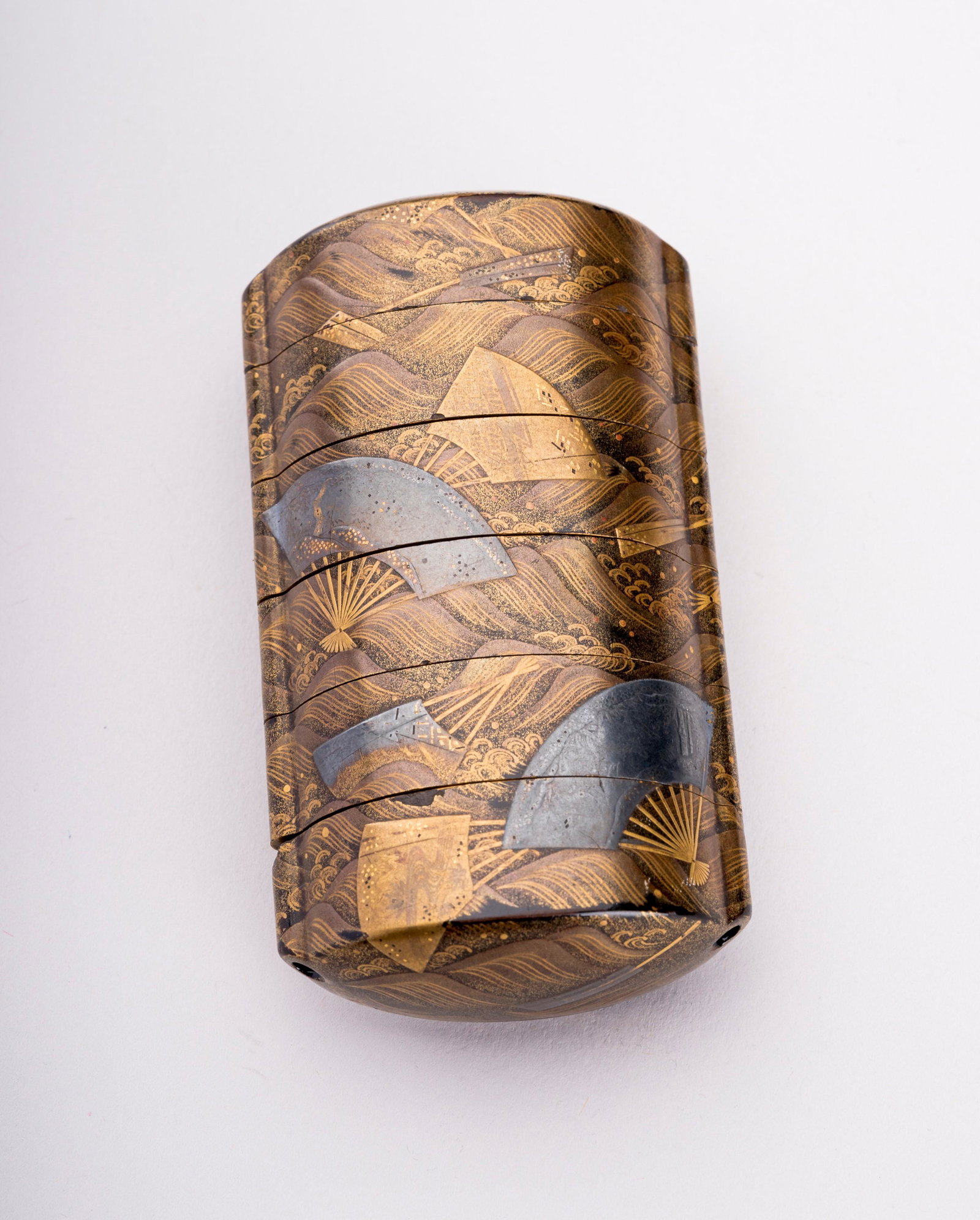 A LACQUERED FIVE CASE INRO DEPICTING FANS, EDO: A LACQUERED FIVE CASE INRO DEPICTING FANS, EDO Japan, 19th century, Edo period (1615-1868) The five-case lacquered inro of an upright rectangular shape and a distinct oval profile, finely decorated in
