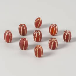 A LOT WITH NINE PYU CARNELIAN AGATE BEADS, c. 7TH - 9TH CENTURY