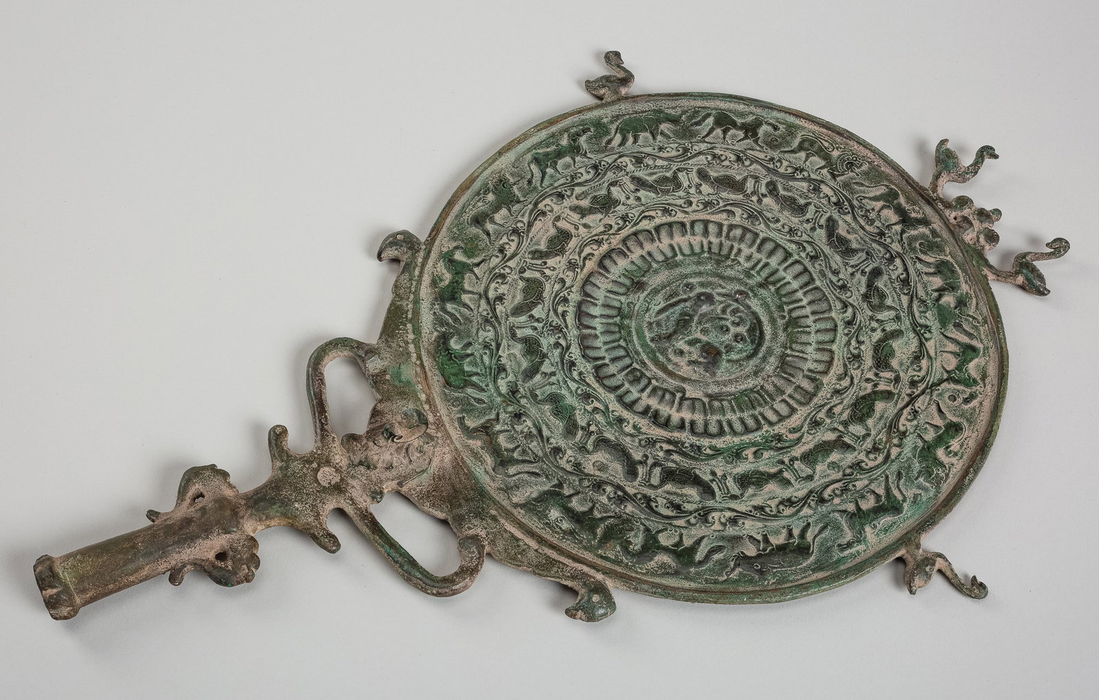 A BRONZE 'PROCESSION OF ANIMALS' MIRROR (1 of 12)
