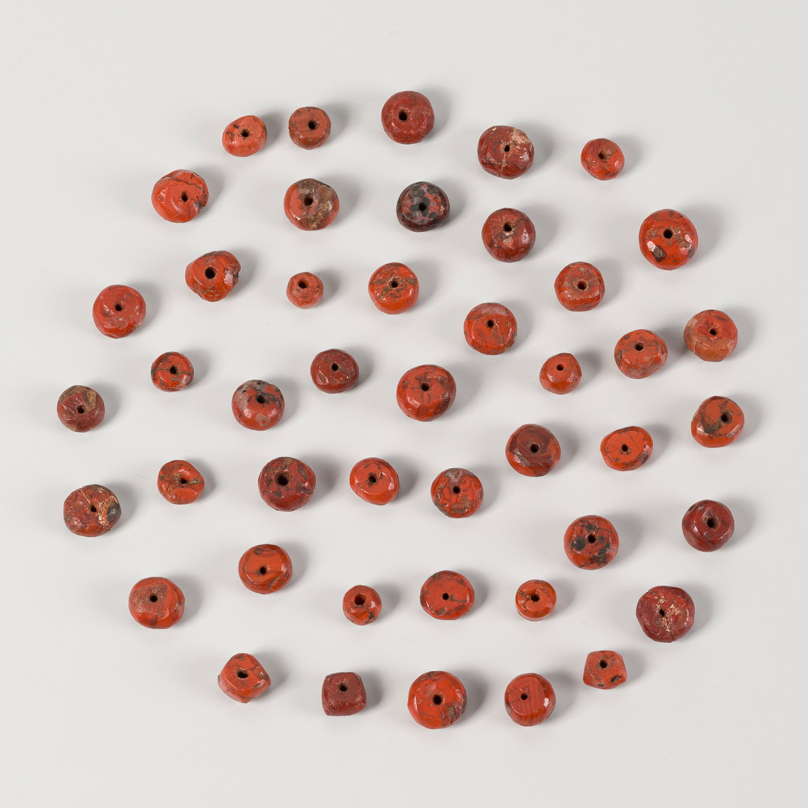 A LOT WITH 45 MESOPOTAMIAN JASPER BEADS, 2000-1500 BC: A LOT WITH 45 MESOPOTAMIAN JASPER BEADS, 2000-1500 BC Central Asia, Ancient region of Mesopotamia, 2000-1500 BC or later. Comprising 45 round beads, slightly different in size, carved from opaque jasp