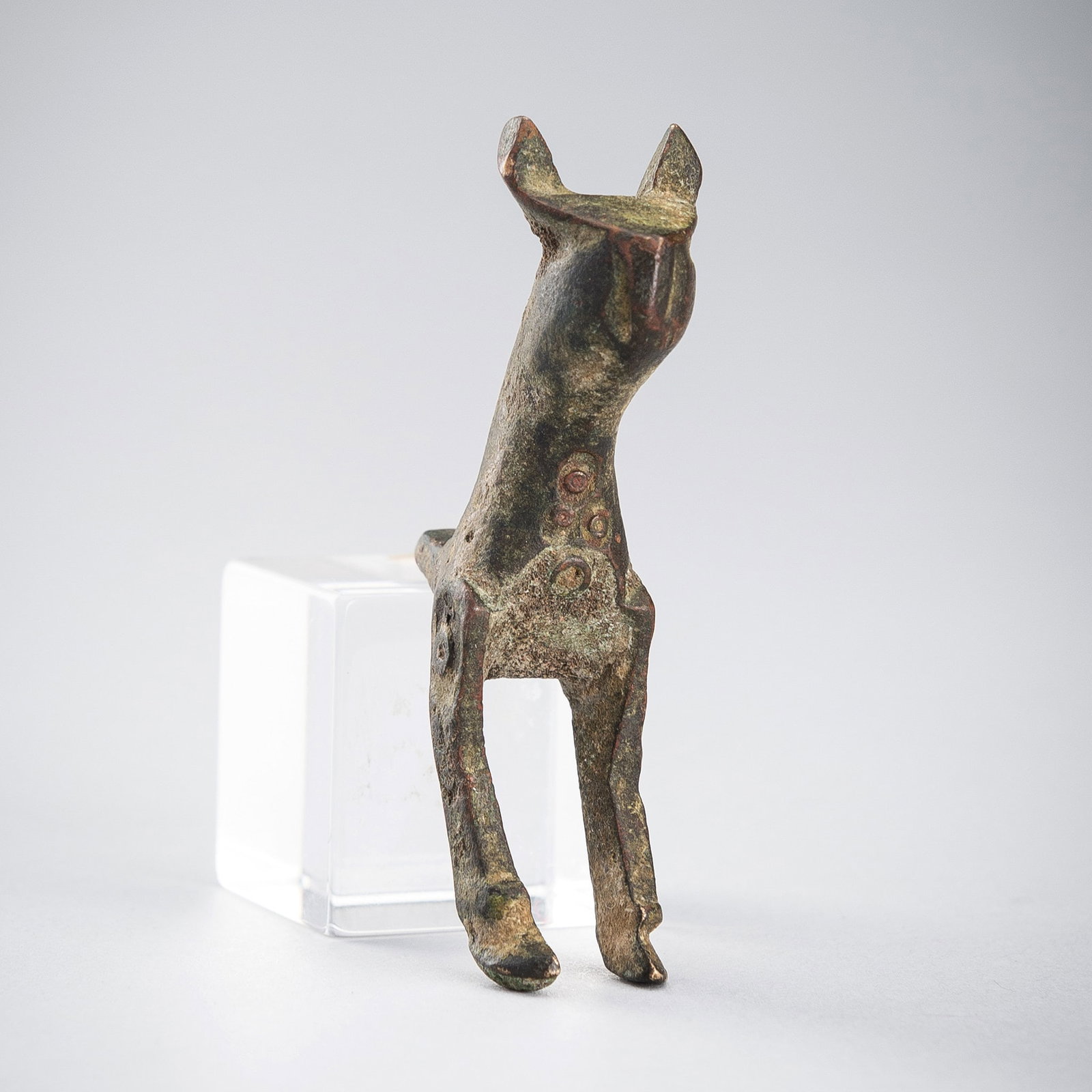 A BRONZE FRAGMENT OF AN ANIMAL, LURISTAN, IRAN, CIRCA 1000-650 BC: A BRONZE FRAGMENT OF AN ANIMAL, LURISTAN, IRAN, CIRCA 1000-650 BC Cast as the front section of a four-legged animal, including the head, neck, and front legs, featuring circular decorative elements. C