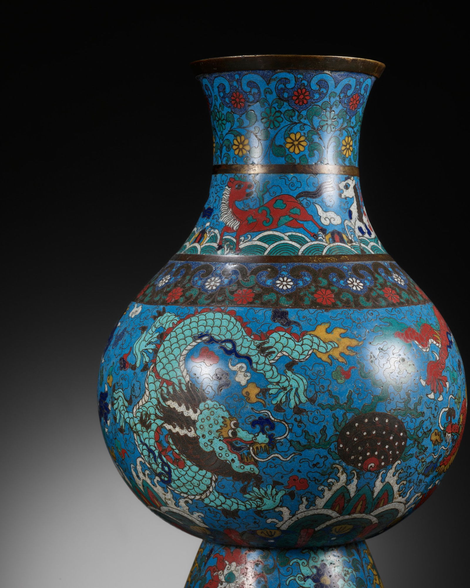 A CLOISONNE ENAMEL 'DRAGONS' VASE, HU, MING DYNASTY: A CLOISONNE ENAMEL 'DRAGONS' VASE, HU, MING DYNASTY China, second half of the 16th century. Of archaistic pear-shaped form, rising from a spreading foot to a waisted neck and flared rim, finely decora