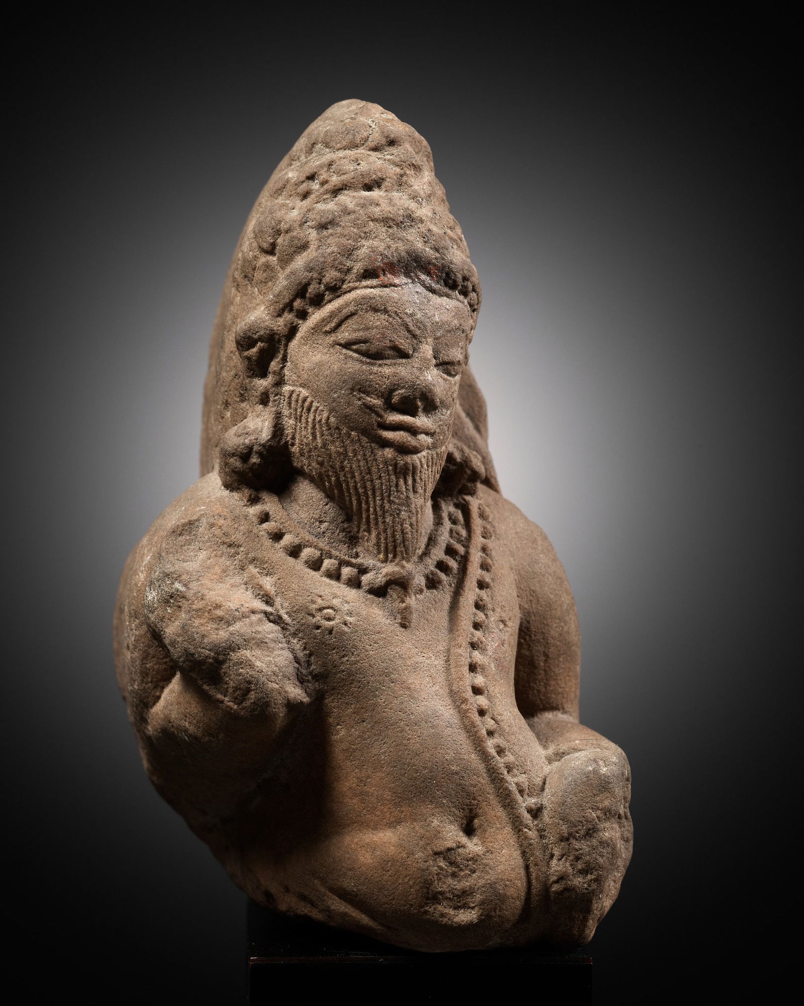 A SANDSTONE FRAGMENT OF A RISHI, CHANDELA DYNASTY, CENTRAL INDIA, 10TH-11TH CENTURY (1 of 12)