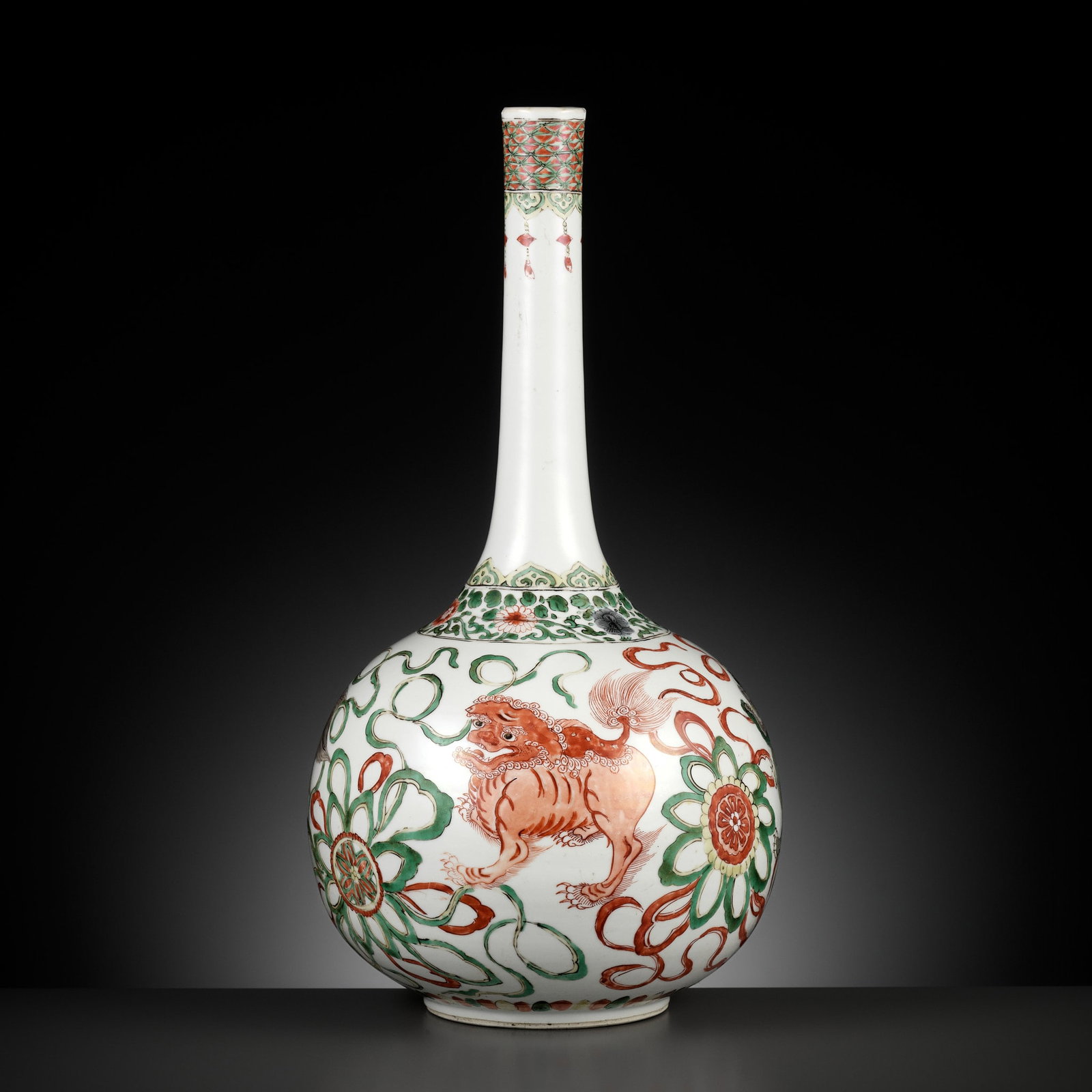 A FAMILLE VERTE 'BUDDHIST LIONS' BOTTLE VASE, KANGXI PERIOD: A FAMILLE VERTE 'BUDDHIST LIONS' BOTTLE VASE, KANGXI PERIOD China, 1662-1722. Of compressed globular form rising from a short circular foot to a tall neck with a gently everted rim, the body brightly 