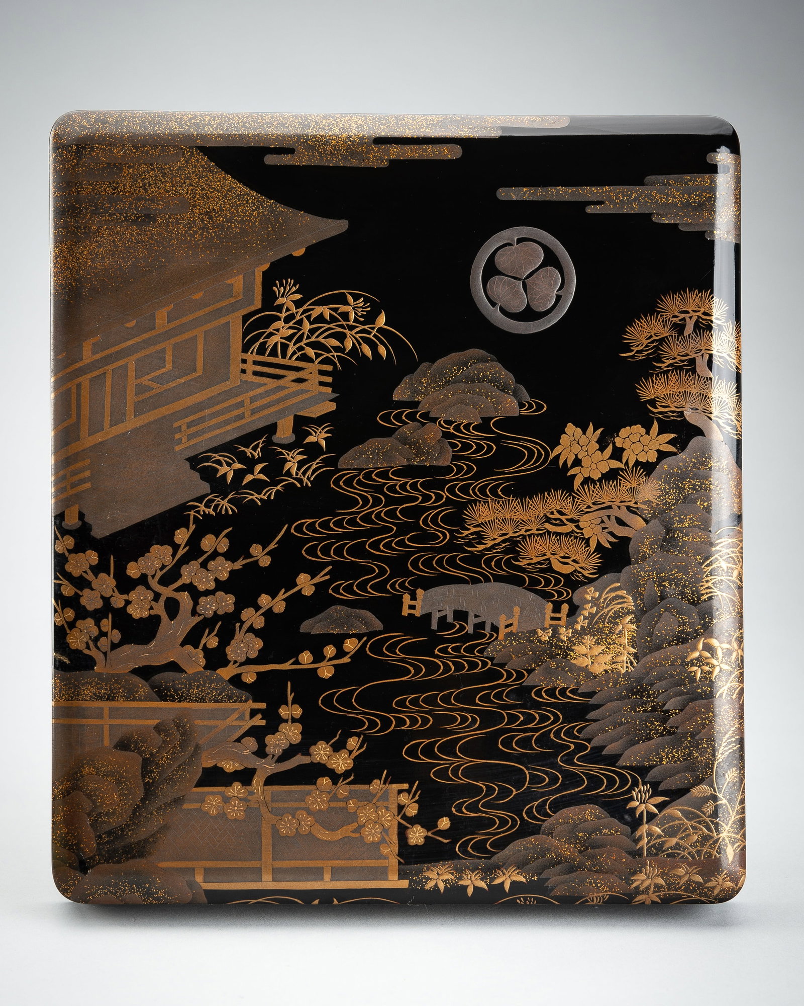 A LACQUER SUZURIBAKO DEPICTING A RIVER LANDSCAPE: A LACQUER SUZURIBAKO DEPICTING A RIVER LANDSCAPE Japan, Meiji period (1868-1912) to Taisho period (1912-1926), first half of 20th century Of rectangular form with rounded edges, the cove