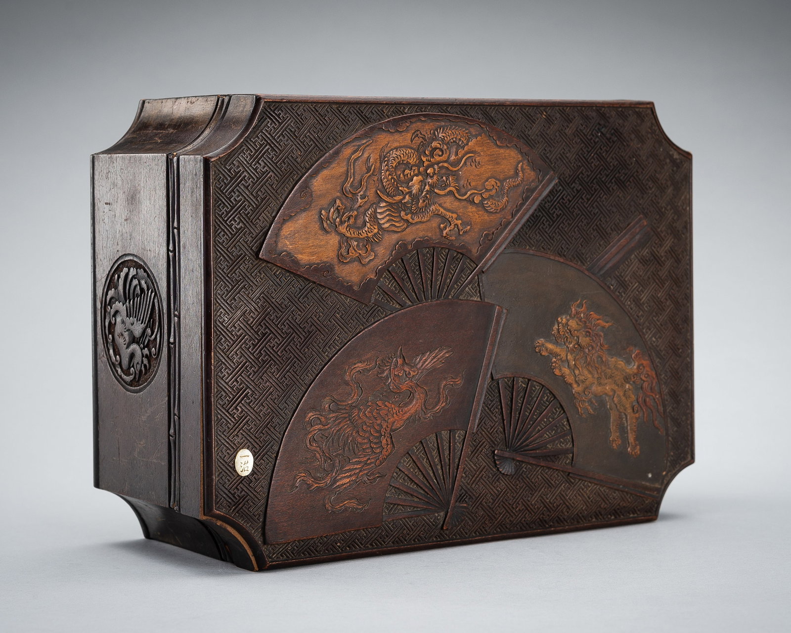 ICHIJI: A CARVED WOOD BOX AND COVER WITH MYTHICAL BEASTS: ICHIJI: A CARVED WOOD BOX AND COVER WITH MYTHICAL BEASTS Signed Ichiji (一治) Japan, Meiji period (1868-1912) Of rectangular form with incurved corners, the top of the cover carved