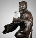 AN IMPRESSIVE BRONZE OKIMONO OF RYUJIN PRESENTING A ROCK CRYSTAL SACRED JEWEL (YASAKANI NO NAGATAMA)