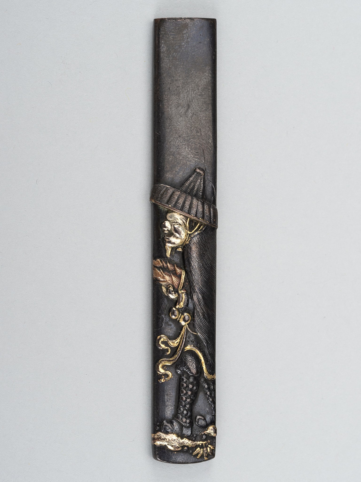 A SHIBUICHI KOZUKA DEPICTING MOSO FARMING BAMBOO: A SHIBUICHI KOZUKA DEPICTING MOSO FARMING BAMBOO Unsigned Japan, 18th to 19th century, Edo period (1615-1868) The migakiji (polished) shibuichi ground worked