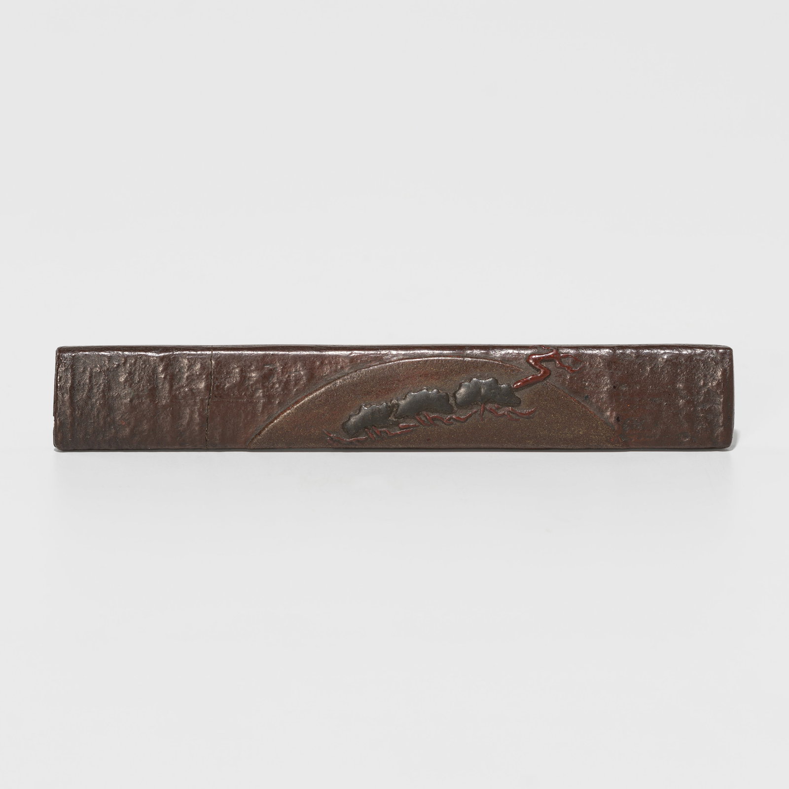 A RARE LACQUERED WOOD KOZUKA DEPICTING PINE TREES AND A RISING SUN: A RARE LACQUERED WOOD KOZUKA DEPICTING PINE TREES AND A RISING SUN Unsigned Japan, 19th century, Edo period (1615-1868) The rare kozuka lacquered in takamaki-e with a p