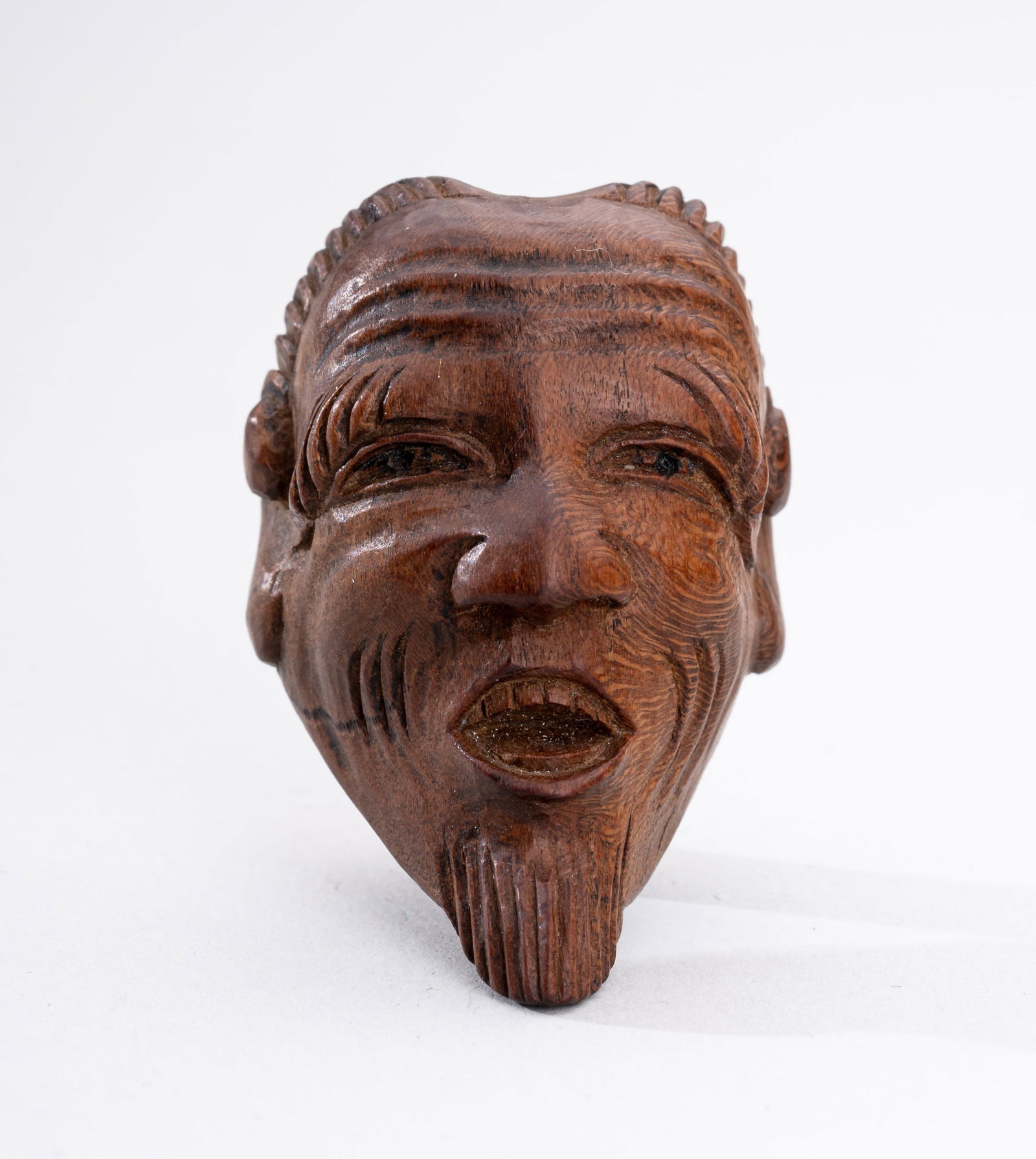A WOOD MASK NETSUKE OF AN OLD MAN (JO): A WOOD MASK NETSUKE OF AN OLD MAN (JO) Unsigned Japan, late 19th centuryOf cheerful countenance, the face carved with narrowed eyes with incised and raised lids below