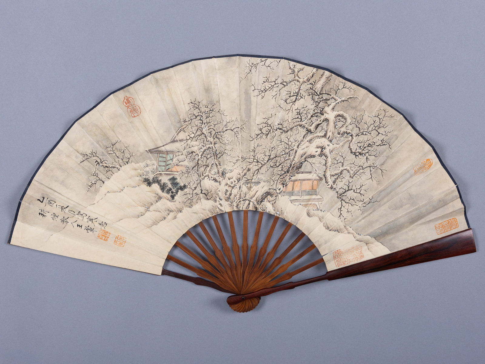A FAN PAINTED WITH A SNOWY LANDSCAPE, AFTER WANG HUI, c 1900s: A FAN PAINTED WITH A SNOWY LANDSCAPE, AFTER WANG HUI, c 1900s China, after Wang Hui (1632-1717) but dating to the late 19th to early 20th century. Ink, watercolors, and gouache on a paper folding fan