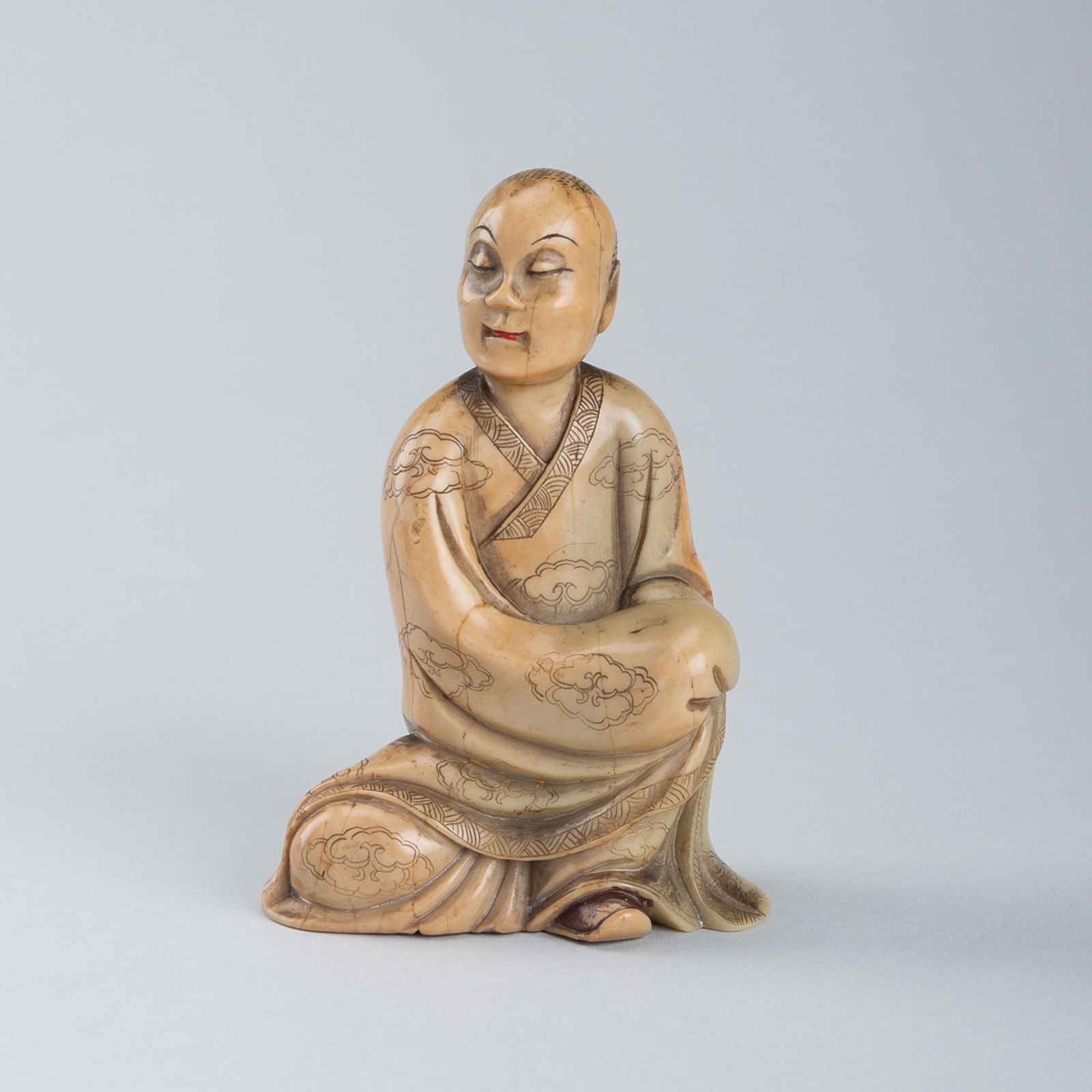 A SOAPSTONE FIGURE OF LUOHAN, QING DYNASTY (1 of 13)