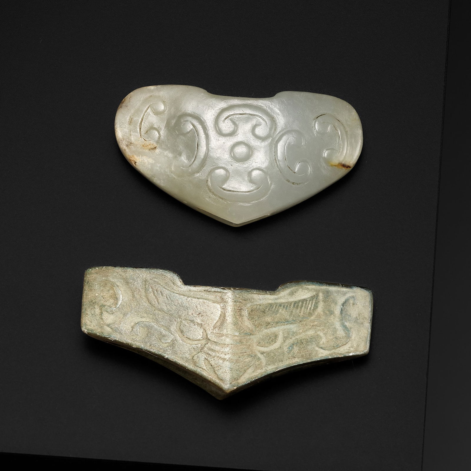 TWO ARCHAIC CELADON JADE SWORD GUARDS, WARRING STATES PERIOD TO HAN DYNASTY (1 of 13)