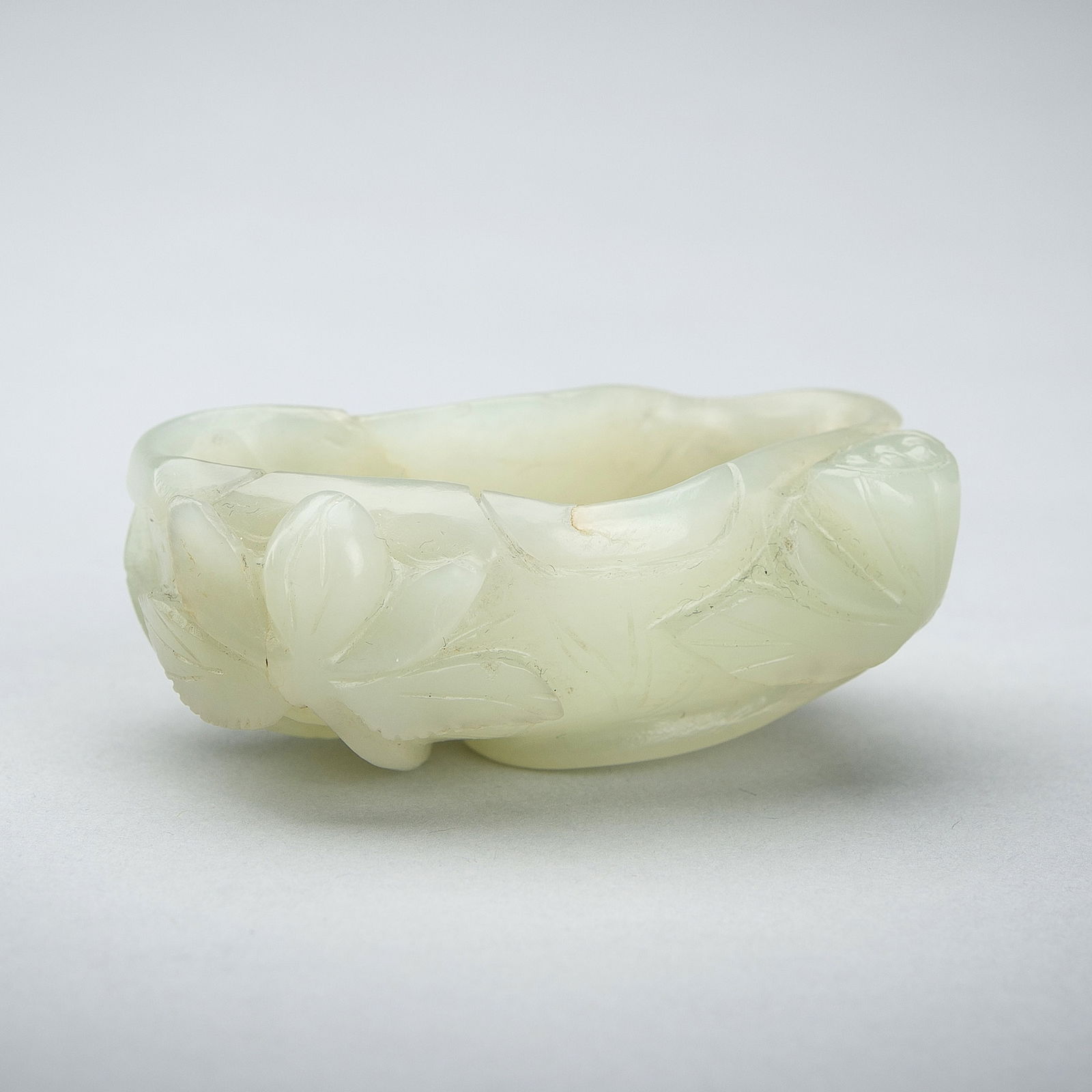 A PALE CELADON JADE 'LOTUS' BRUSHWASHER, QING DYNASTY (1 of 14)