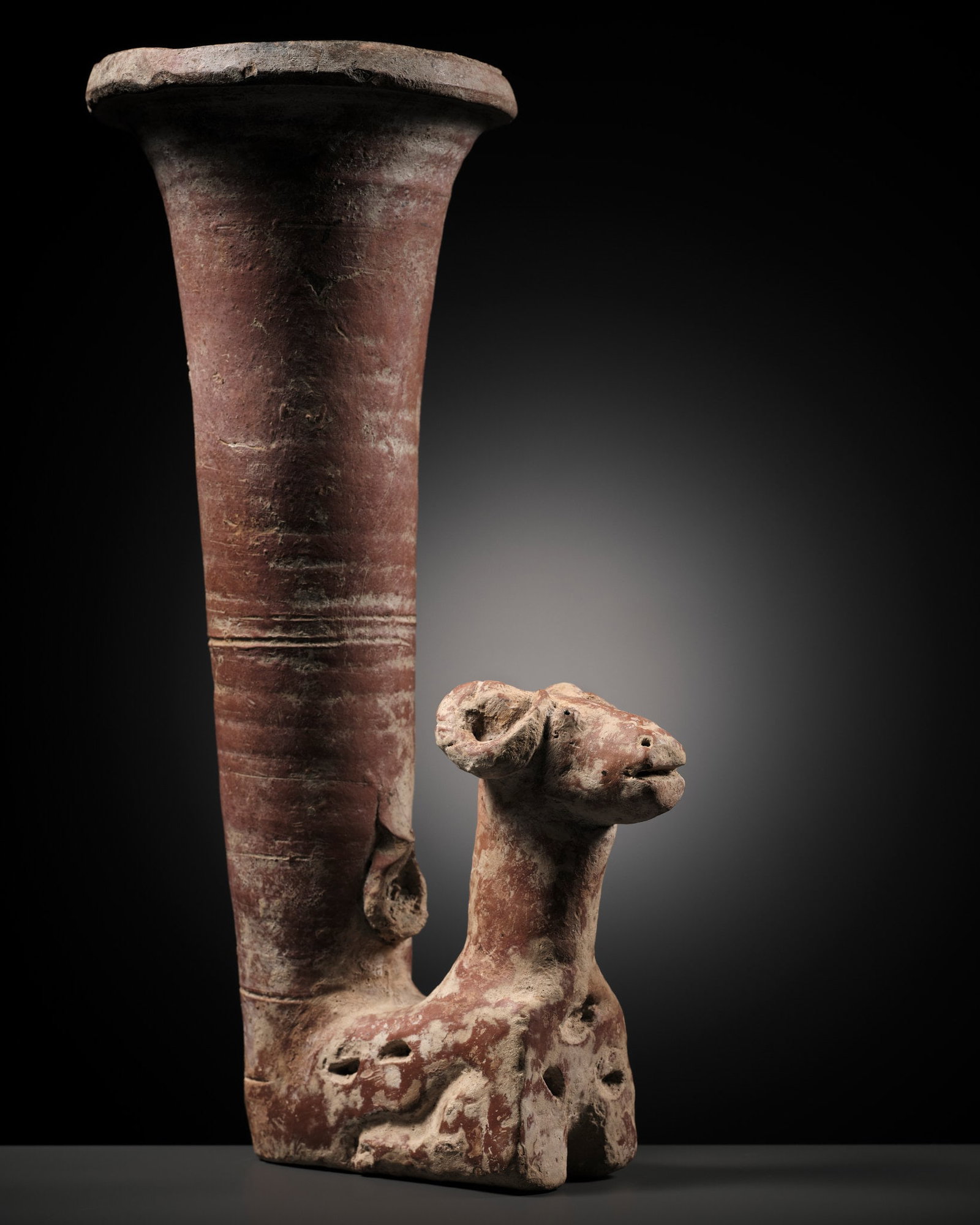 A LARGE PERSIAN POTTERY 'RAM' RHYTON, 1ST MILLENNIUM AD: A LARGE PERSIAN POTTERY 'RAM' RHYTON, 1ST MILLENNIUM AD Scientific Analysis Report: A thermoluminescence analysis report issued by Oxford Authentication on 11 July 2024, based on sample number N124f88