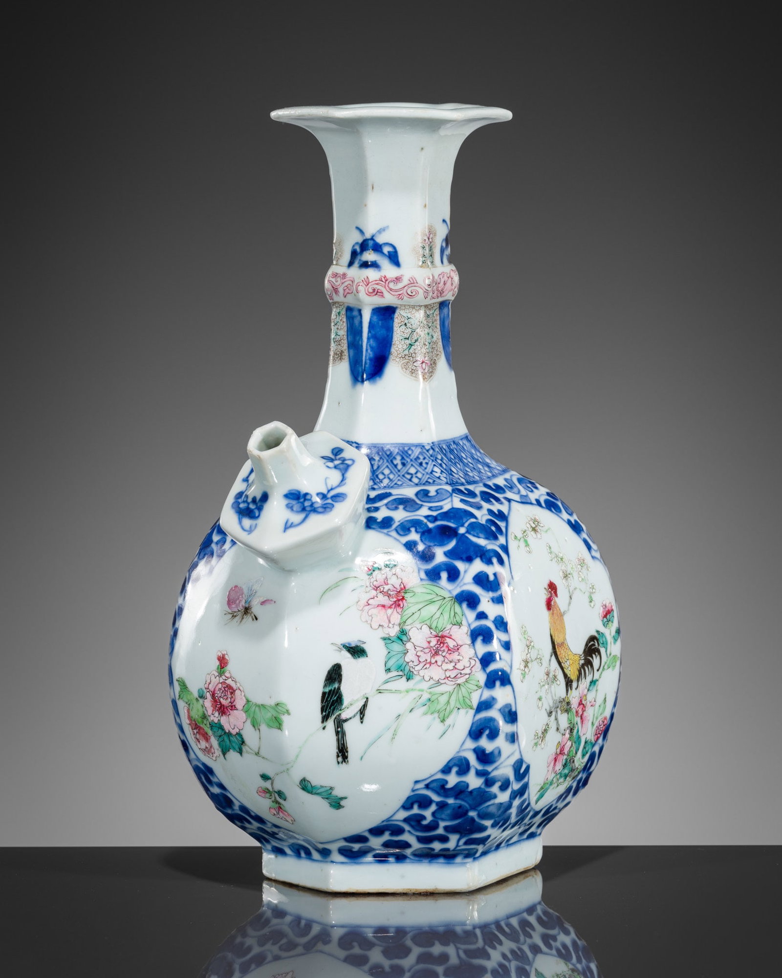 A HEXAGONAL FAMILLE ROSE 'ROOSTER' KENDI, 18TH CENTURY: A HEXAGONAL FAMILLE ROSE 'ROOSTER' KENDI, 18TH CENTURY China. Finely potted, the faceted globular sides supported on a short foot, the shoulder surmounted by a similarly shaped spout and tall neck wit