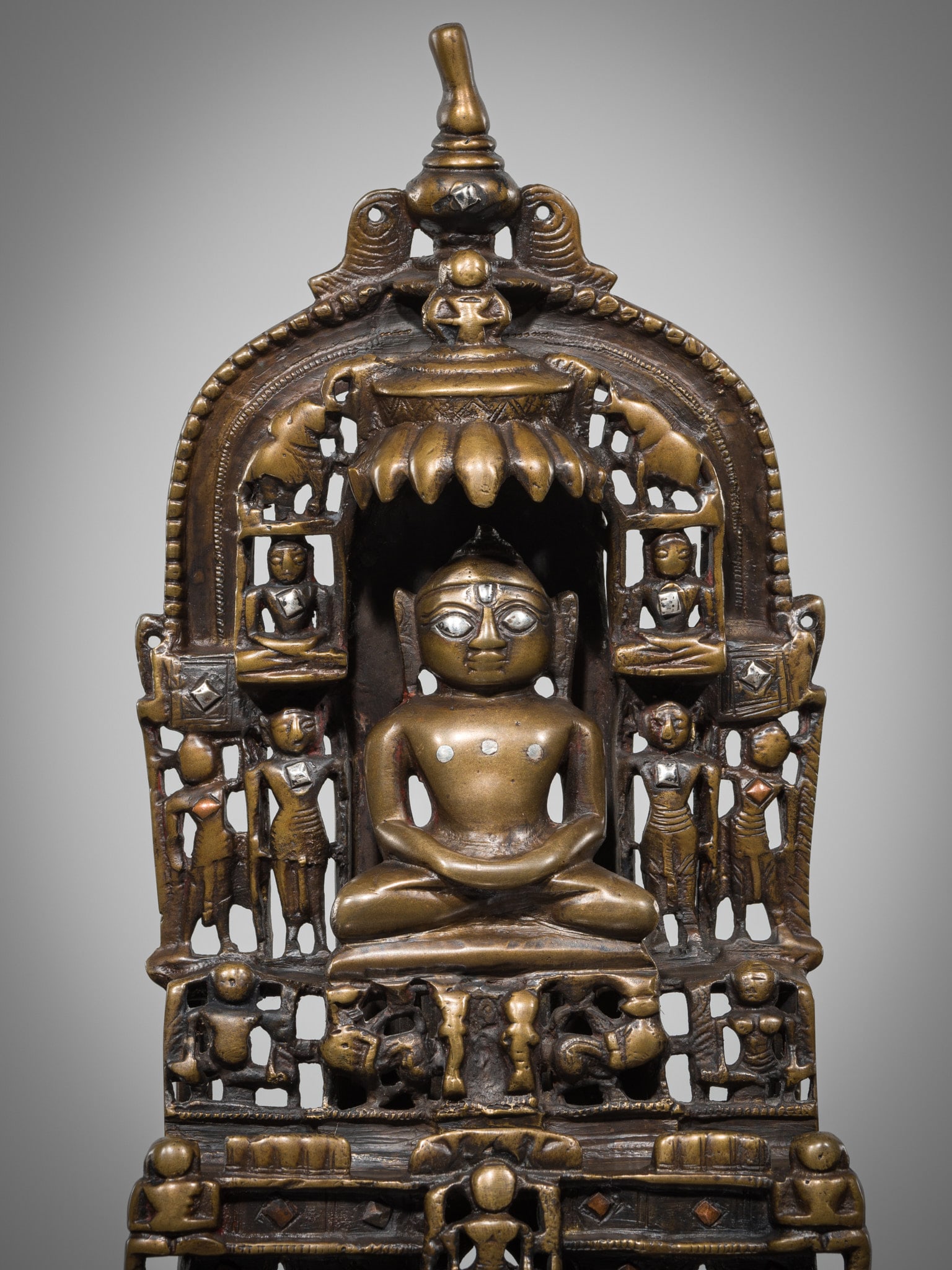 A JAIN COPPER- AND SILVER-INLAID BRASS SHRINE TO PARSHVANATHA, DATED 1488 (1 of 10)
