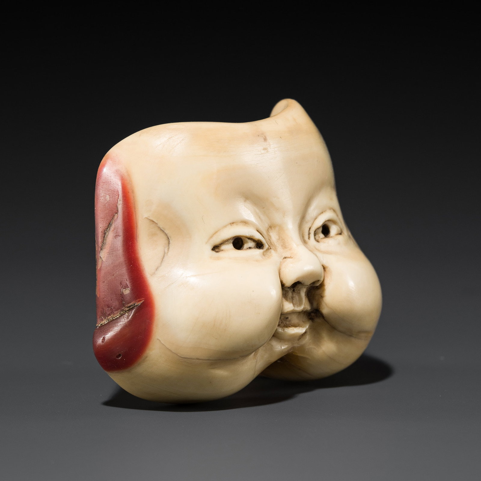 A RARE HONEN (HORNBILL) MASK NETSUKE OF FUKUSUKE (1 of 7)