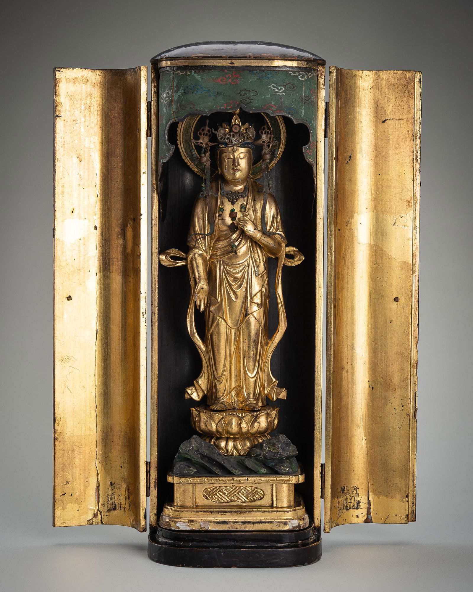 A LACQUERED WOOD ZUSHI (PORTABLE SHRINE) CONTAINING A GILT WOOD FIGURE OF KANNON (1 of 20)