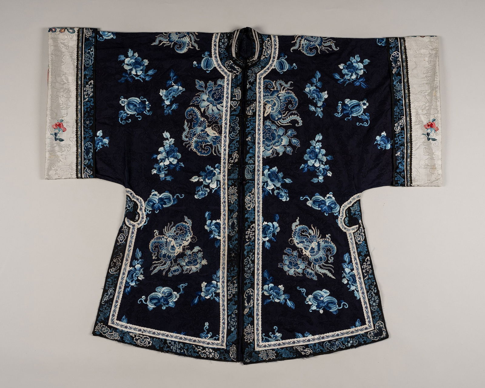 A BLUE EMBROIDERED SILK 'BUTTERFLIES' LADY'S INFORMAL ROBE, QING DYNASTY (1 of 18)