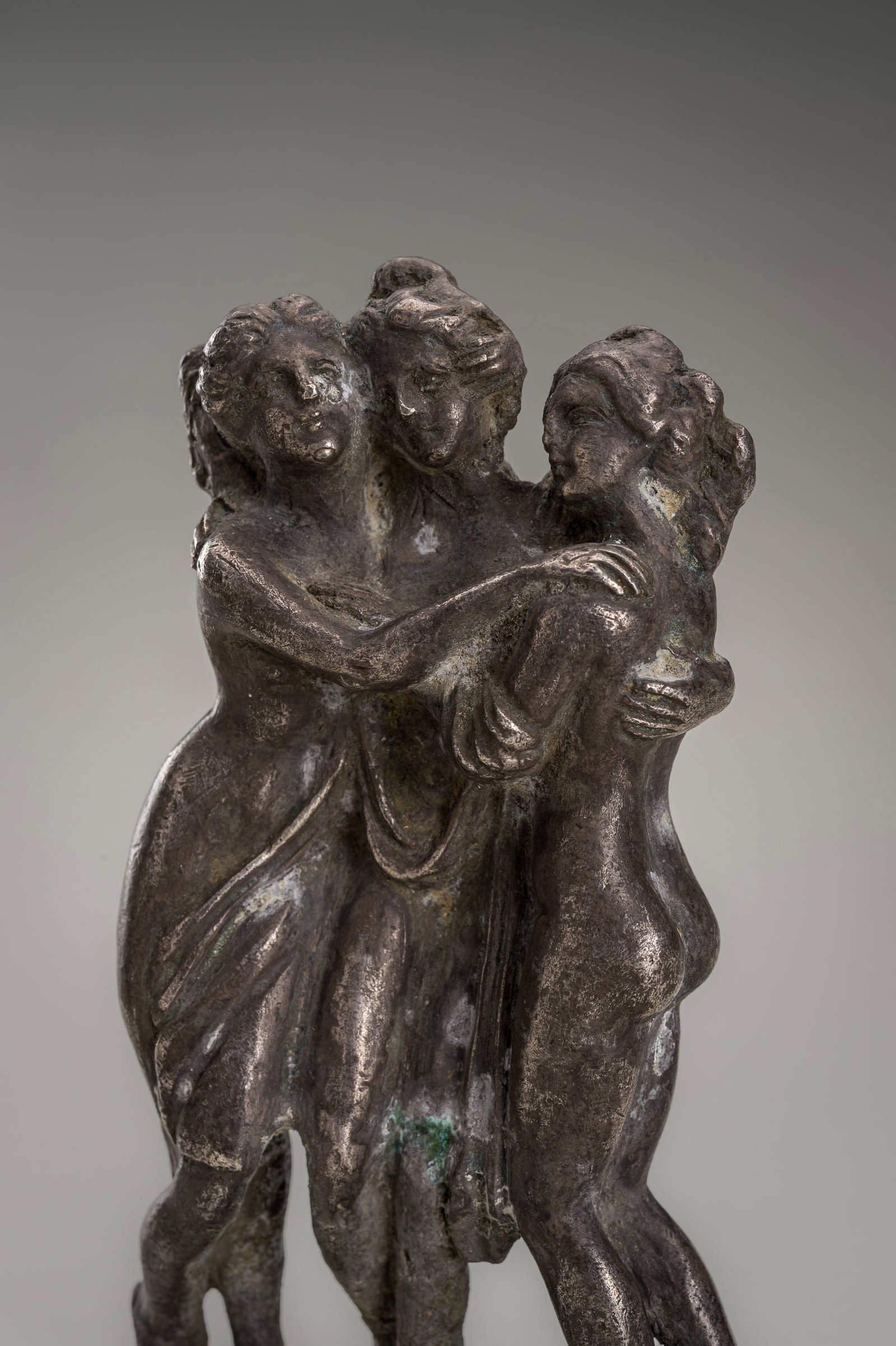 A SILVER FIGURE OF THE THREE GRACES, STYLE OF THE GRECO-BACTRIAN KINGDOM: A SILVER FIGURE OF THE THREE GRACES, STYLE OF THE GRECO-BACTRIAN KINGDOM Style of the greco-bactrian Kingdom, but dating later, presumably to the 18th century. Depicting the Three Graces in their typi