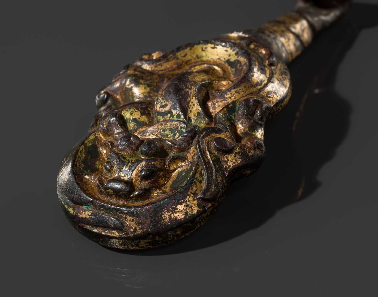 A GILT-BRONZE 'MYTHICAL BEAST' BELT HOOK, WARRING STATES PERIOD (1 of 13)