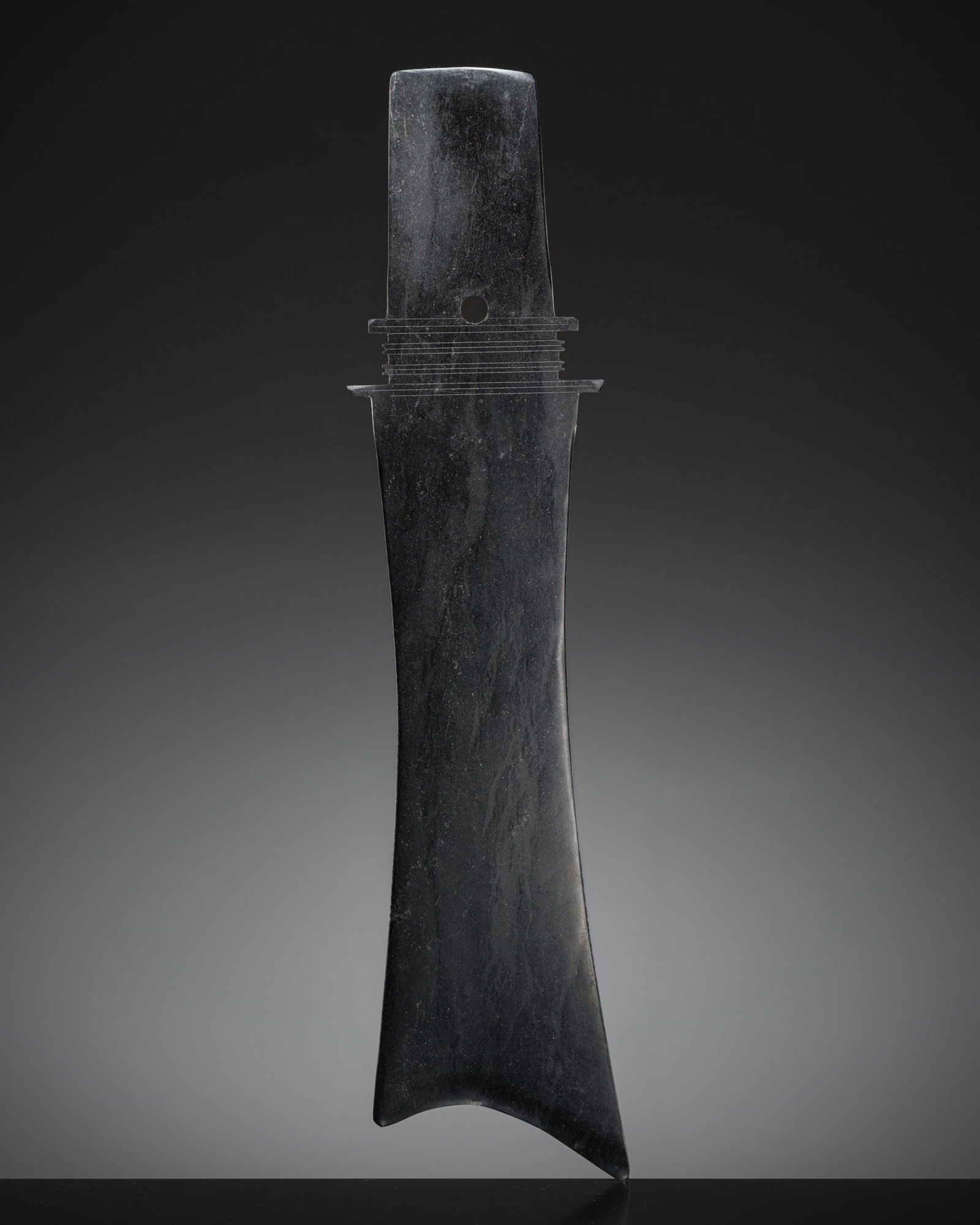 A BLACK JADE CEREMONIAL BLADE, ZHANG, WESTERN ZHOU DYNASTY: A BLACK JADE CEREMONIAL BLADE, ZHANG, WESTERN ZHOU DYNASTY Expert authentication: Dr. Gu Fang has examined the present lot and guarantees its authenticity and the dating above, noting the style of cut
