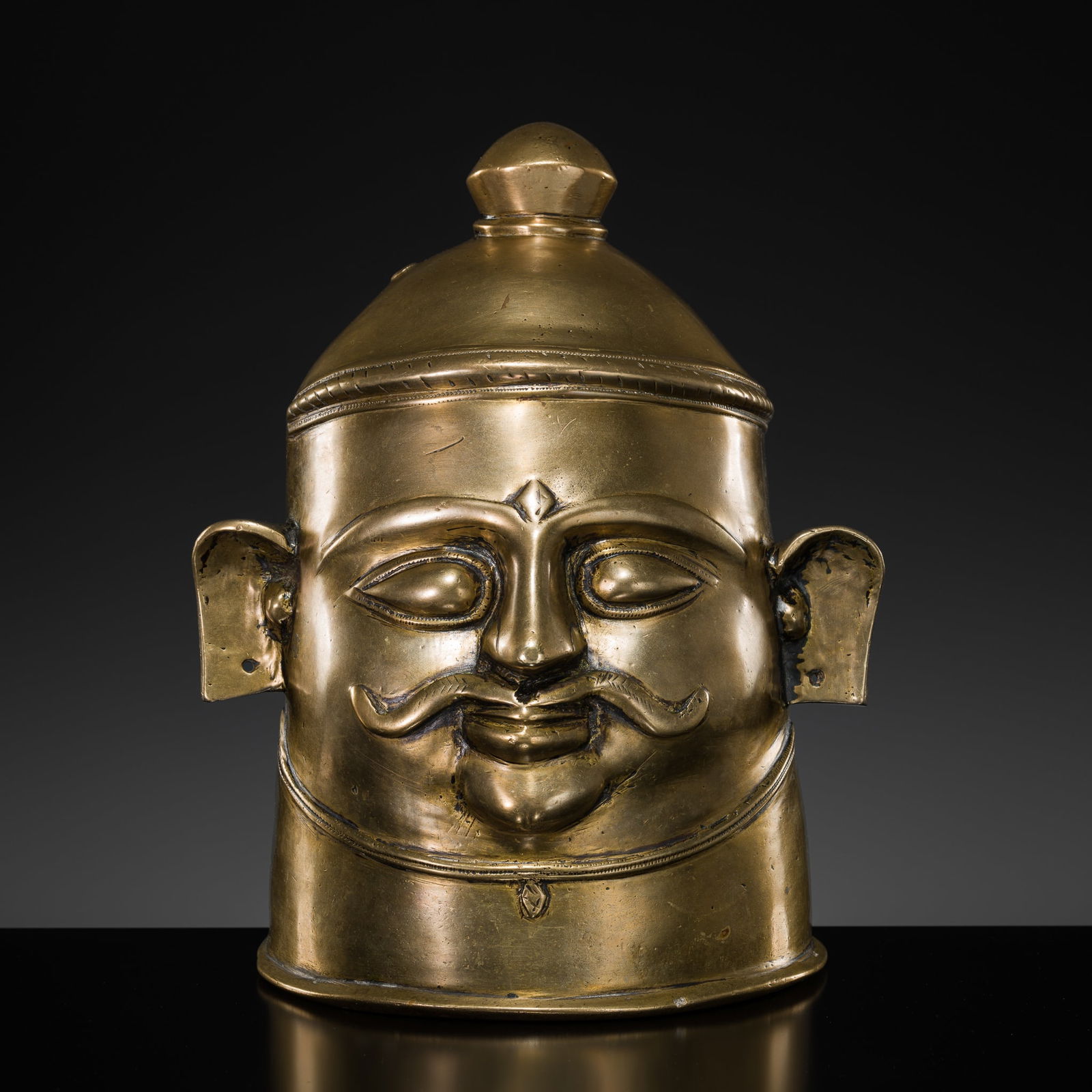 A BRASS LINGAM COVER IN THE FORM OF A HEAD, 17TH-18TH CENTURY (1 of 8)