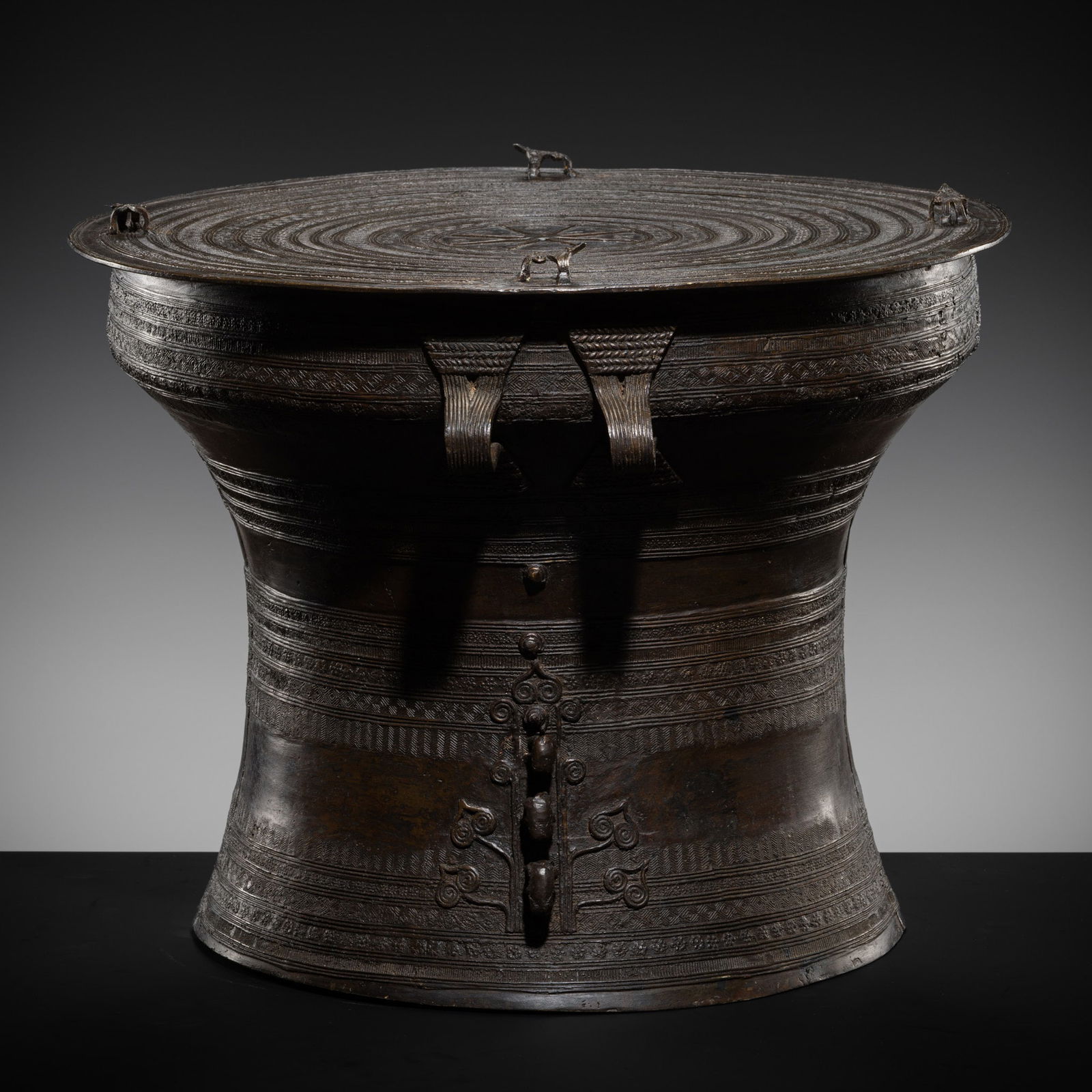 A BRONZE RAIN DRUM, KAREN PEOPLE, REGION OF MYANMAR AND THAILAND, 19TH CENTURY OR EARLIER: A BRONZE RAIN DRUM, KAREN PEOPLE, REGION OF MYANMAR AND THAILAND, 19TH CENTURY OR EARLIER The drum shows a central eight-ray star medallion on the flat top encircled by concentric bands of decoration