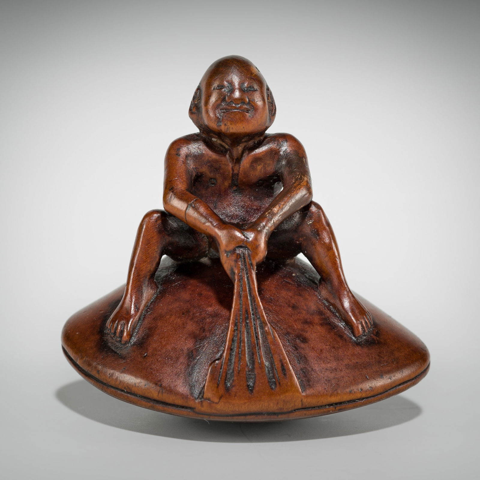 GYOKUSAI: A FINE WOOD SHUNGA NETSUKE OF MAN ON A HAMAGURI CLAM (1 of 11)