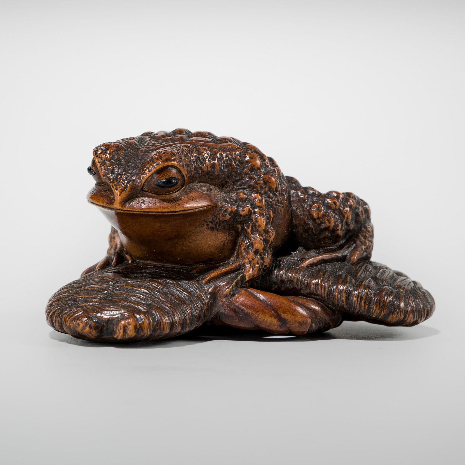 MASATADA: A FINE WOOD NETSUKE OF A TOAD ON A WARAJI (1 of 10)