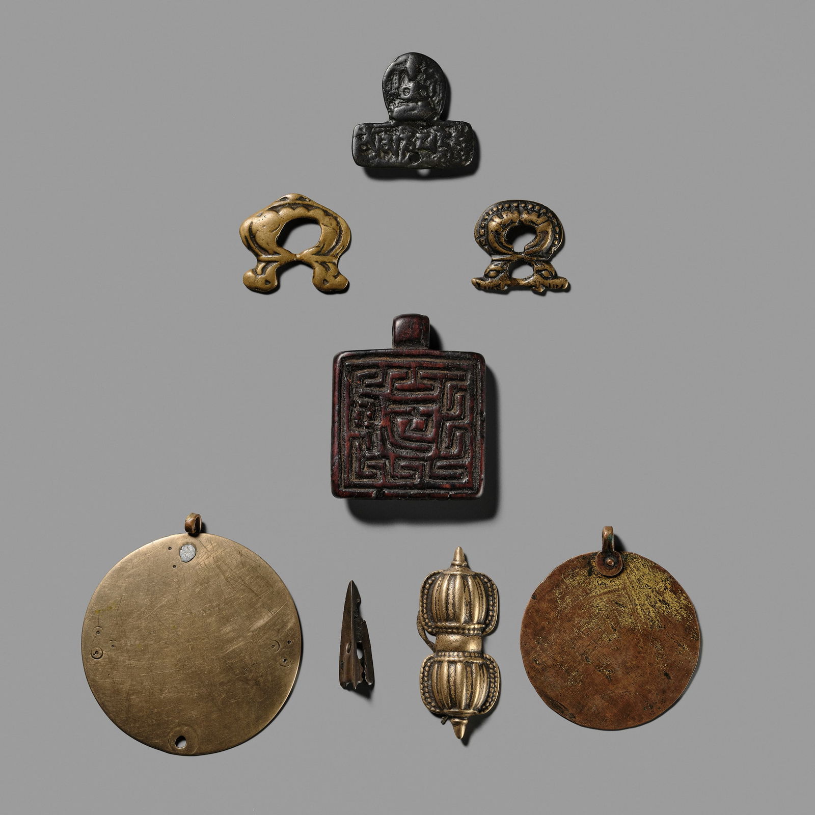 A GROUP OF THOGCHAGS, MELONG, AND PENDANTS, 12TH-15TH CENTURY