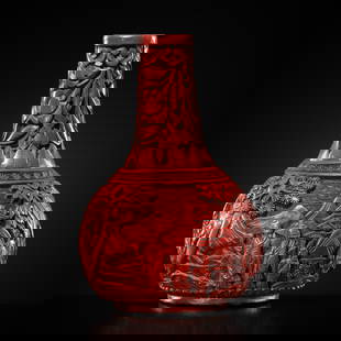 A SMALL CINNABAR LACQUER BOTTLE VASE, 18TH CENTURY: A SMALL CINNABAR LACQUER BOTTLE VASE, 18TH CENTURY China. The globular body surmounted by a cylindrical neck tapering towards the mouth, raised on a circular foot, finely carved through the lacquer wi