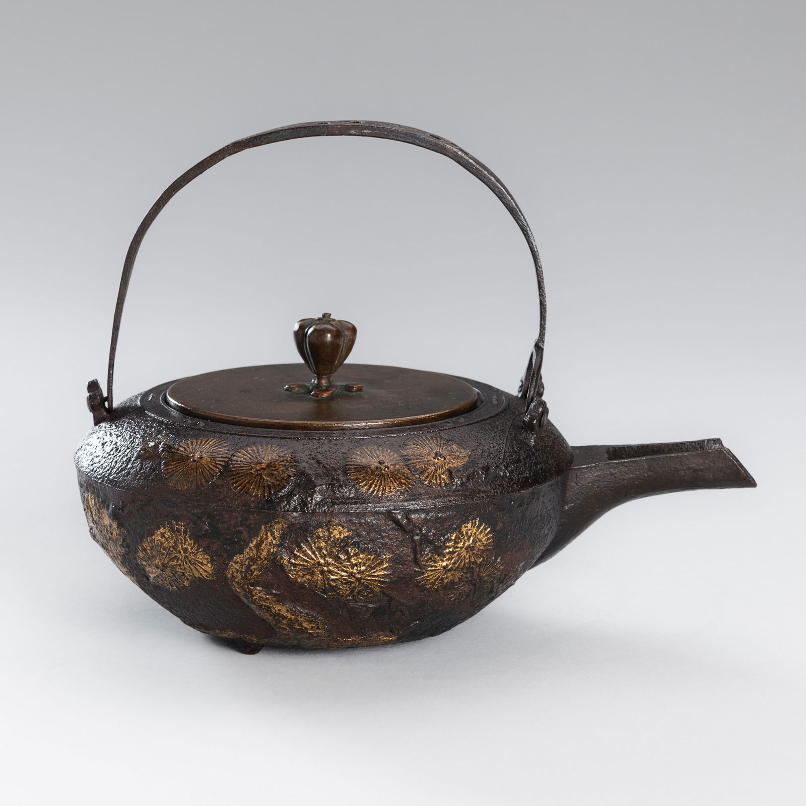 A SILVER-INLAID IRON TETSUBIN (TEA KETTLE) WITH PINE BRANCHES