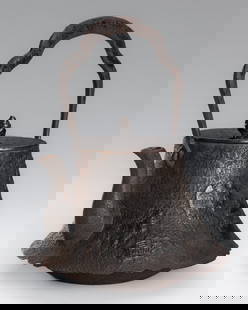 AN IRON TETSUBIN (TEA KETTLE) WITH CHINESE INSCRIPTIONS: AN IRON TETSUBIN (TEA KETTLE) WITH CHINESE INSCRIPTIONS Japan, Meiji period (1868-1912)The sides flaring toward an irregularly scalloped rim above the rounded tapered foot, set with an elegant, upturn