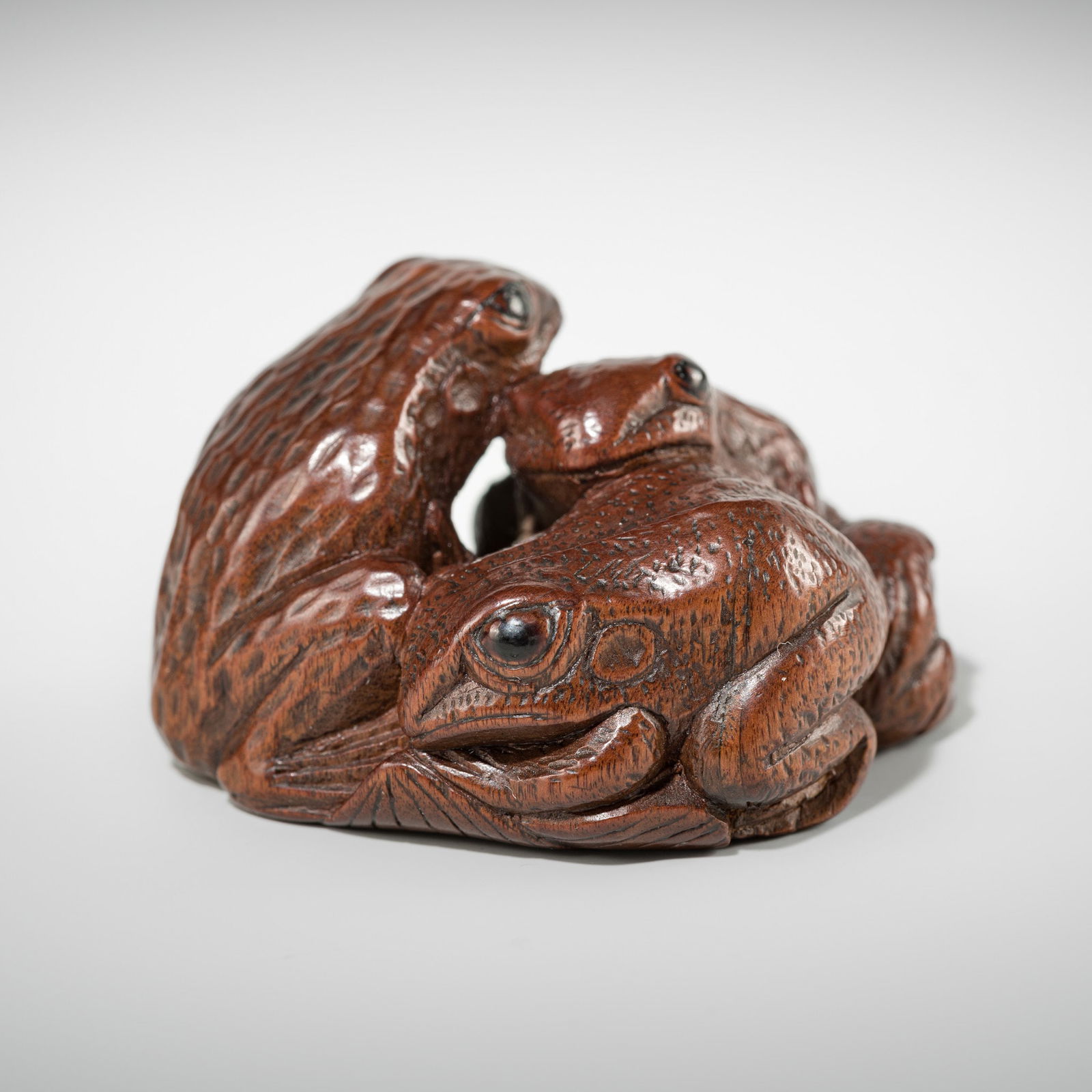 SENKO: A WOOD NETSUKE OF FROGS AND LOTUS (1 of 10)