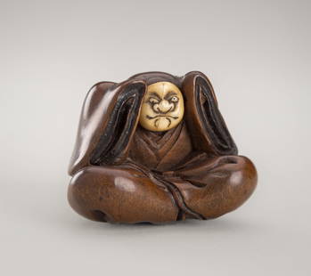 MIWA: A FINE INLAID WOOD NETSUKE OF A KARAKO WITH A BUAKU MASK: MIWA: A FINE INLAID WOOD NETSUKE OF A KARAKO WITH A BUAKU MASK By Miwa, signed Miwa &#19977;&#-28886; with 'seal' kakihanJapan, Edo (Tokyo), c. 1800, Edo period (1615-1868)Finely carved as a seated bo