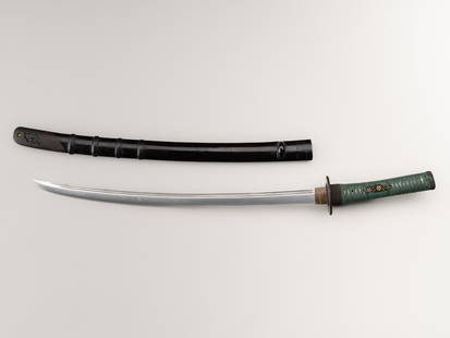 A WAKIZASHI IN KOSHIRAE: A WAKIZASHI IN KOSHIRAE Japan, Edo period (1615-1868)The blade:Shobu-zukuri with iori-mune, the hamon is sugu in nioi-deki, the hada is mukome. The blade with two bohi (bloodlines) to each si