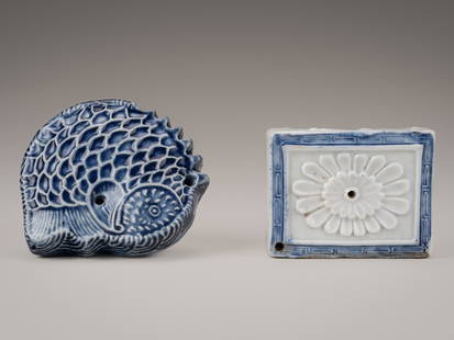 A LOT WITH TWO BLUE AND WHITE PORCELAIN KOREAN WATER DROPPERS: A LOT WITH TWO BLUE AND WHITE PORCELAIN KOREAN WATER DROPPERS Korea, late 19th century  One shaped as a fish, its body curled back on itself, with two holes pierced to either side of its head, the sca