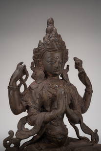 A BRASS FIGURE OF AVALOKITESHVARA: A BRASS FIGURE OF AVALOKITESHVARA Nepal, 20th century. Seated in dhyanasana on a double lotus base, holding his principle hands in anjali mudra and his secondary hands holding mala prayer beads and a