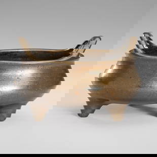 A BRONZE TRIPOD CENSER, 17TH- 18TH CENTURY: A BRONZE TRIPOD CENSER, 17TH- 18TH CENTURY China. The compressed globular body raised on three conical feet, with a pair of 'bridge'-shaped handles that rise in a graceful curve from the rim. The base