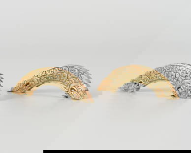 A PAIR OF ARCHAISTIC 'DOUBLE-DRAGON' PENDANTS, HUANG, QING OR EARLIER: A PAIR OF ARCHAISTIC 'DOUBLE-DRAGON' PENDANTS, HUANG, QING OR EARLIER China, Qing dynasty (1644-1912) or earlier. Each of crescent shape, finely worked with scrolling motif in low relief, the ends wor