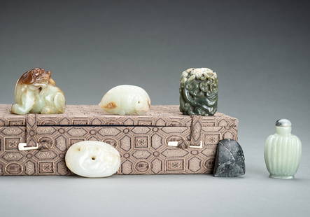 A FINE GROUP OF SIX JADE ITEMS: A FINE GROUP OF SIX JADE ITEMS China, Qing Dynasty (1644-1912) to Republic period (1912-1949) or earlier. The first a carving of a seated Buddhist lion holding a ruyi spring in its mouth, the stone of